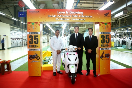 (Right to Left) Honda 2Wheelers India's Sr Vice president, Mr Yadvinder Singh Guleria, President &amp; CEO, Mr Minoru Kato and General Manager Tapukara Plant, Mr. Naveen Awal roll out Honda'